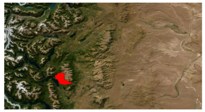Mapa satelital que muestra una región montañosa con un área resaltada en rojo cerca de un cuerpo de agua.

Descripción generada con IA